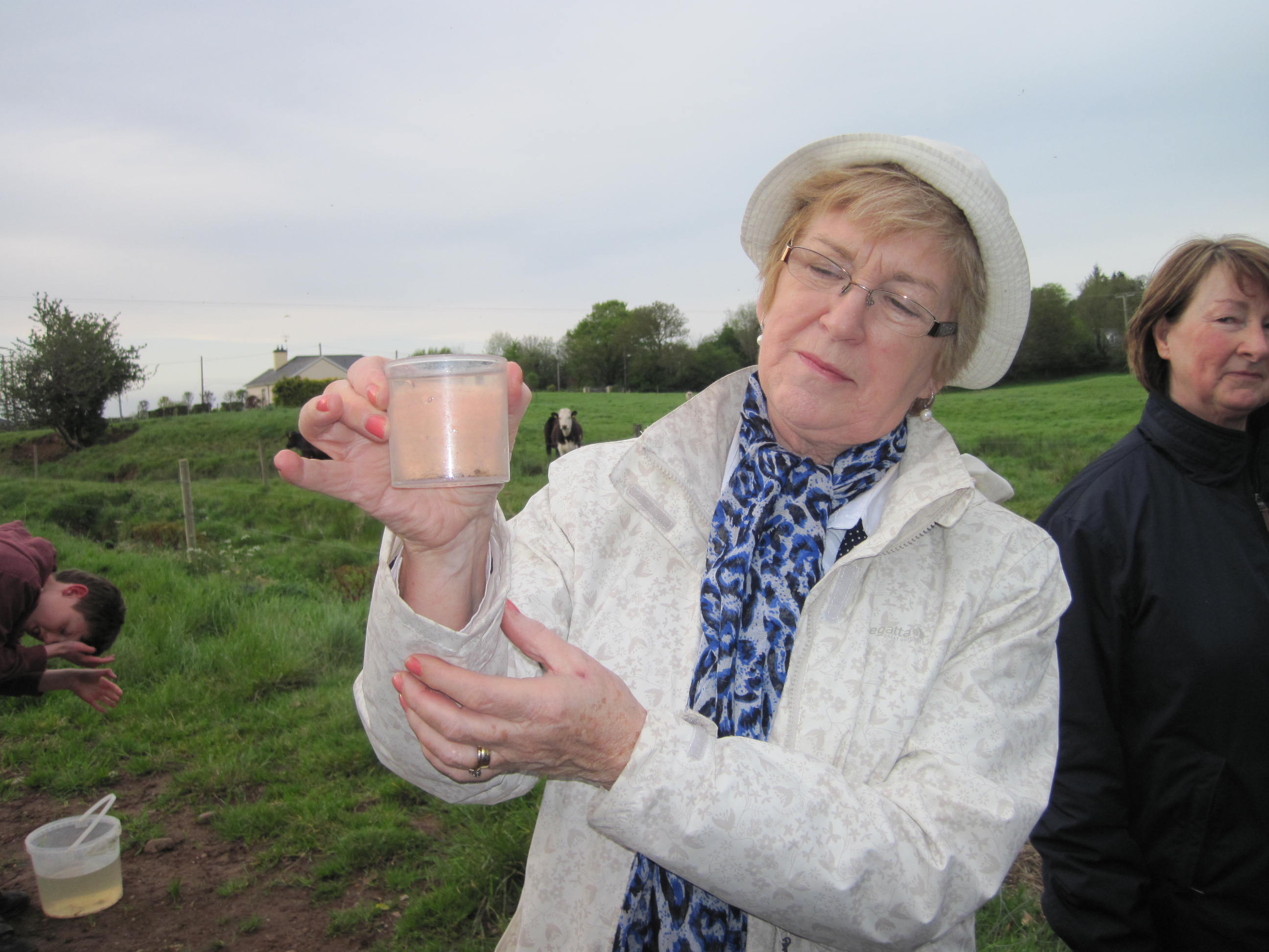 Limerick County Councillor, Brigid Teefy examining a trout fry