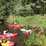 Local kids get to try out a kayak under expert supervision