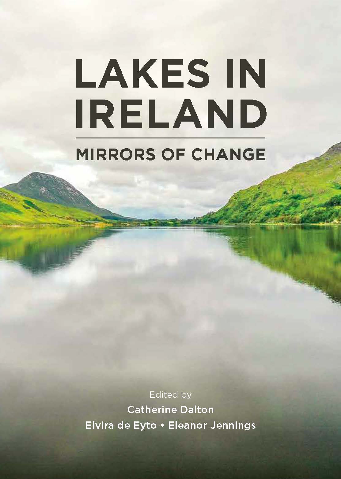 Cover of the book titled “Lakes in Ireland: Mirrors of Change.” The design features a calm lake reflecting green hills and a cloudy sky, with mountains in the background. Text on the cover includes the title in large bold letters and the editors’ names: Catherine Dalton, Elvira de Eyto, and Eleanor Jennings.